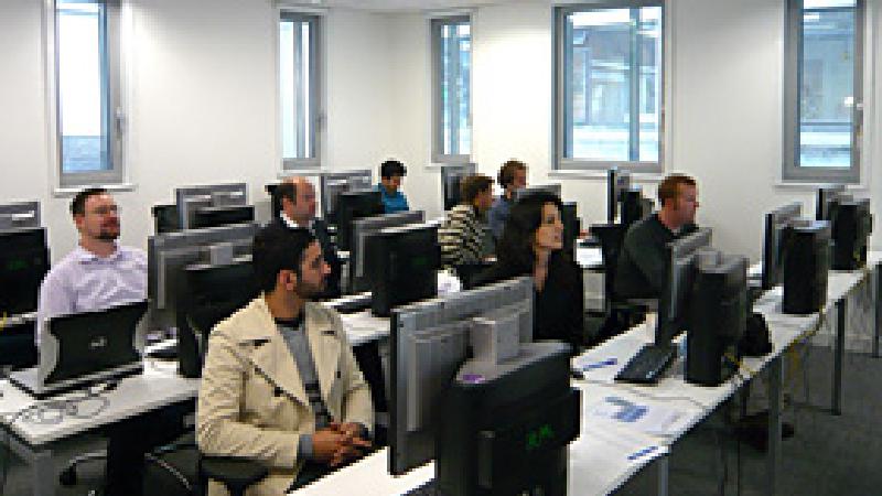 students in a classroom sitting in front on computer screens in several rows learning Rhino 3D